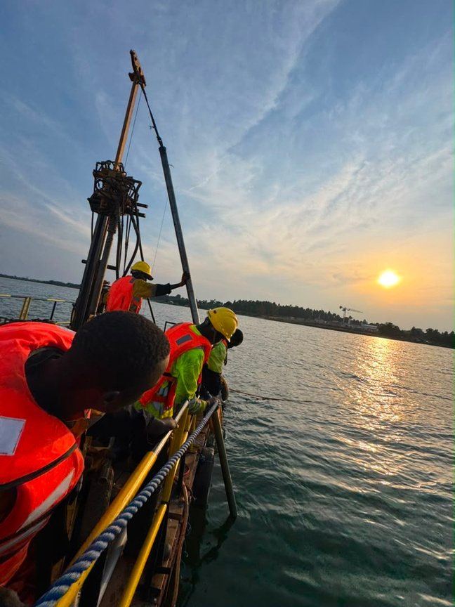 Over-water drilling platform at sunset on Lake Victoria